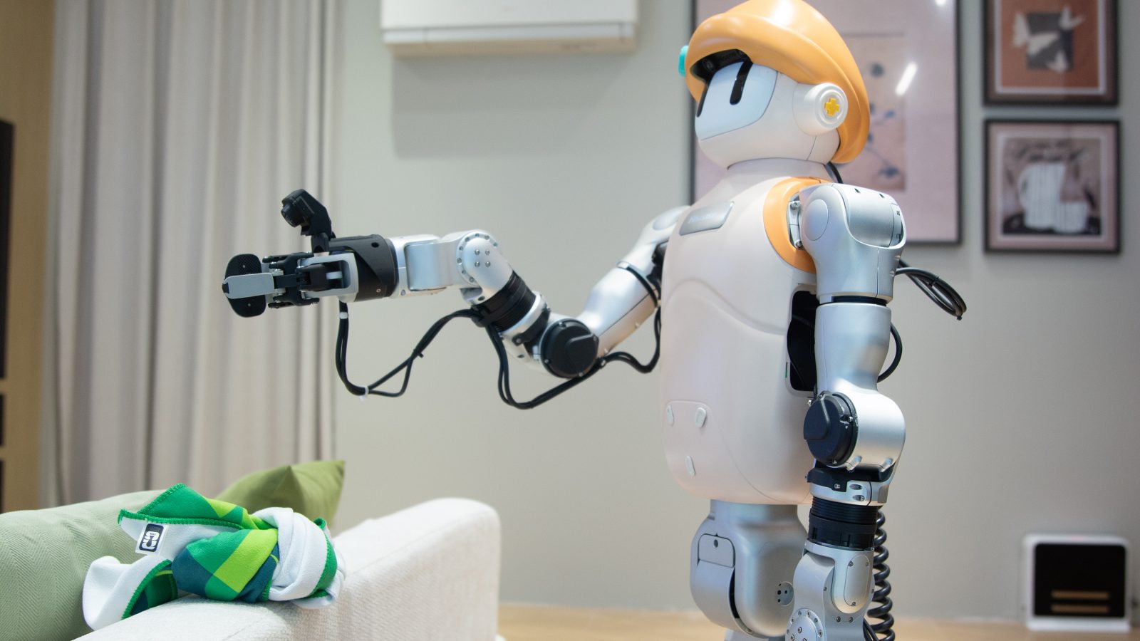 Worker wearing head-mounted cameras demonstrating household chores to generate humanoid-robot training data in China