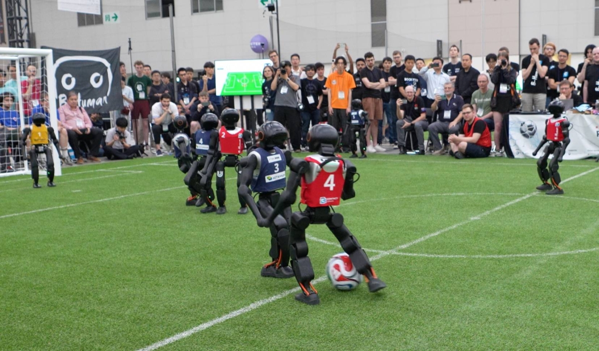 Booster Robotics humanoid robots playing 11-a-side autonomous football at RoboCup 2026
